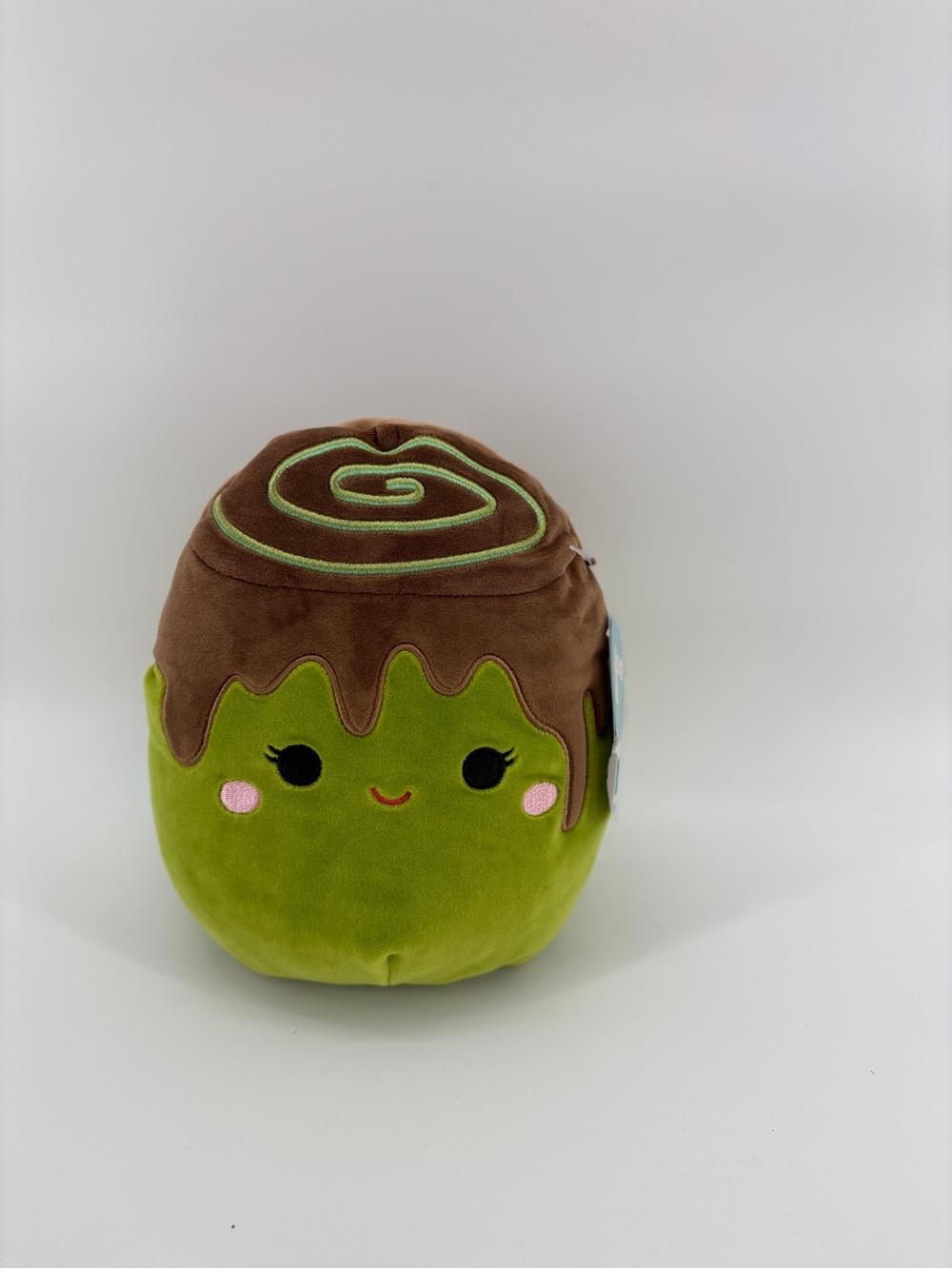 The Squishmallows Malta the Matcha Cinnamon Roll 8-Inch Plush is an 8-inch plush
